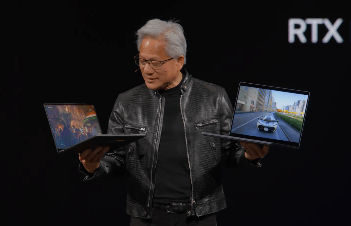 NVIDIA CEO Jensen Huang holding RTX Spark laptops at Computex 2026